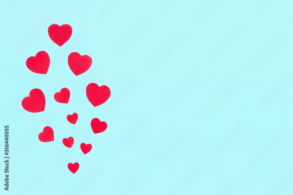 Valentine's Day background. Red hearts pattern on pastel blue background. Valentines day, love minimal concept. Flat lay, top view, copy space.