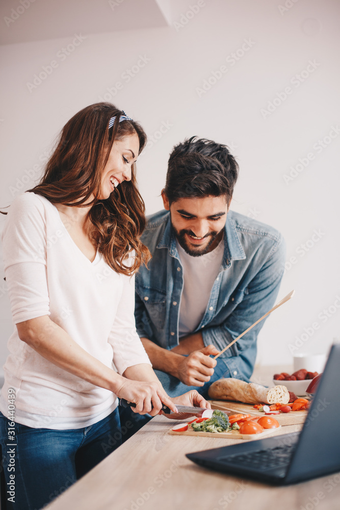 A man and a woman preparing a meal at the kitchen counter. A man and a woman preparing a meal at the kitchen counter.