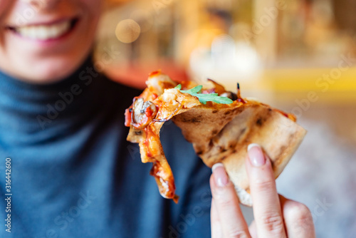 woman eating pizza in the cafe
