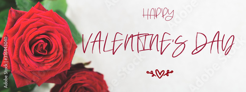 Bunch of Red Roses with Happy Valentines Day letters on light grey background, banner size