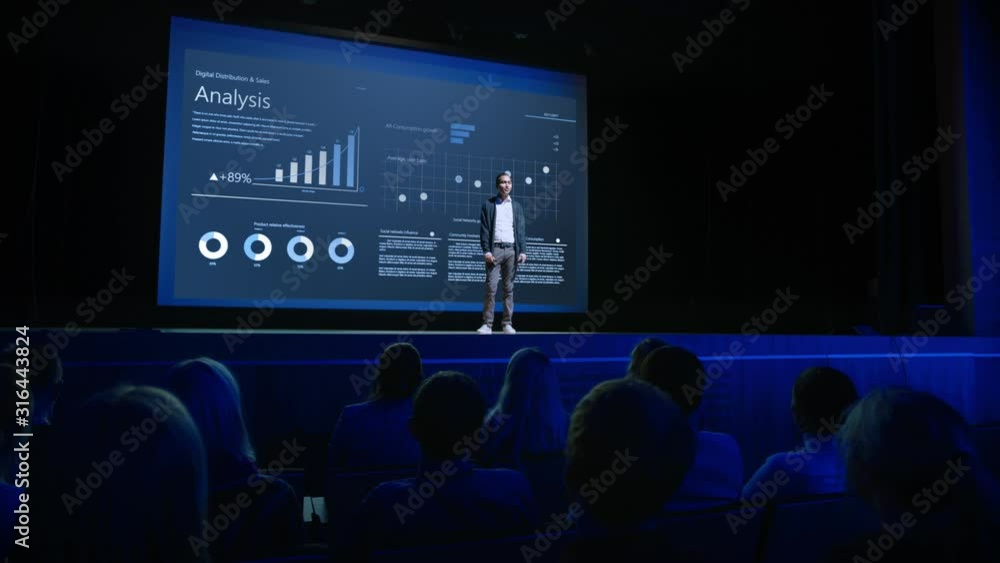 Business Forum Economics Conference Stage: Professional Speaker Concludes His Report with a Speech and Showing Infographics, Statistics on the Big Screen. Audience Applauds