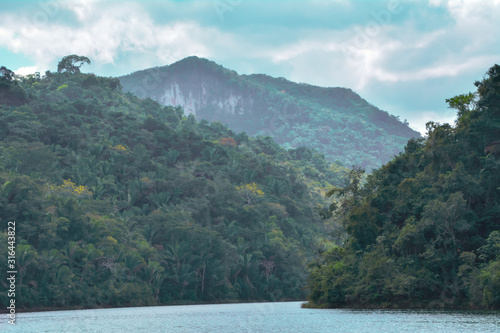 Macal River Valley, Cayo District, Belize. Scene of lush hazy forested limestone hills .