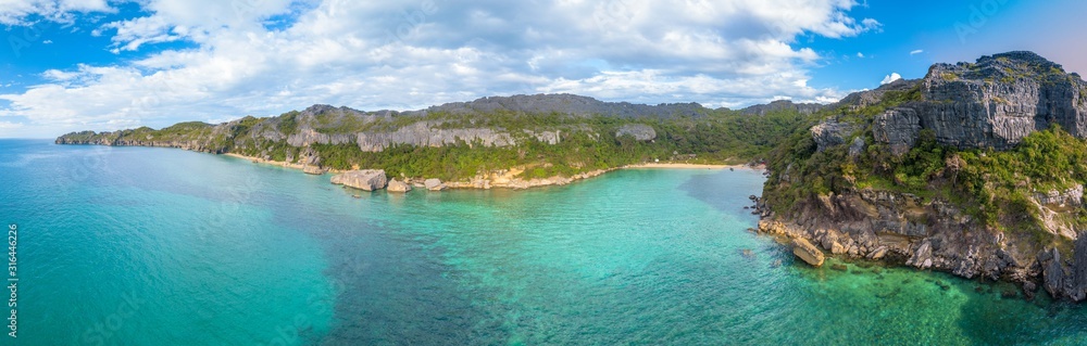 Aerial drone panorama of uninhabited pristine tropical island with limestone rock formation (nosy hara/ madagascar)