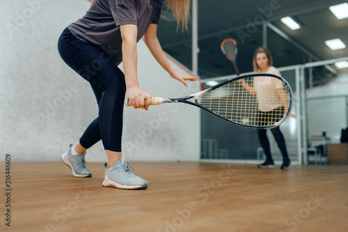Two female players with rackets, squash game © Nomad_Soul