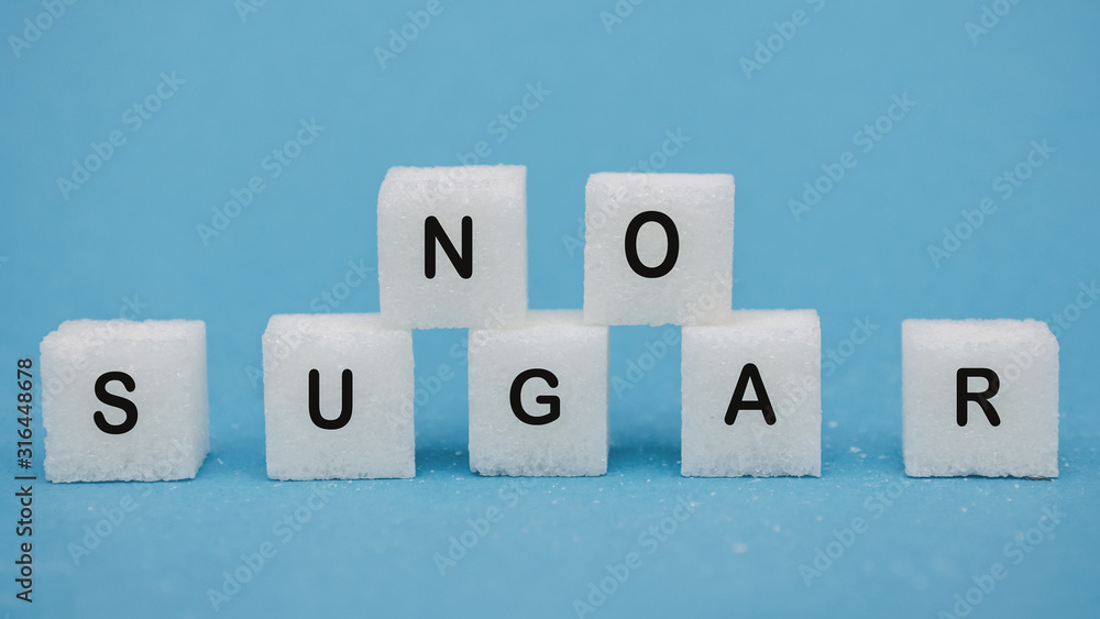 Sugar cubes on a blue background. Healthy lifestyle concept. Life without diabetes Sugar cubes on a blue background. Healthy lifestyle concept. Life without diabetes