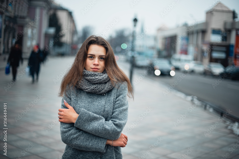 Girl in a gray coat in the winter in the city Girl in a gray coat in the winter in the city