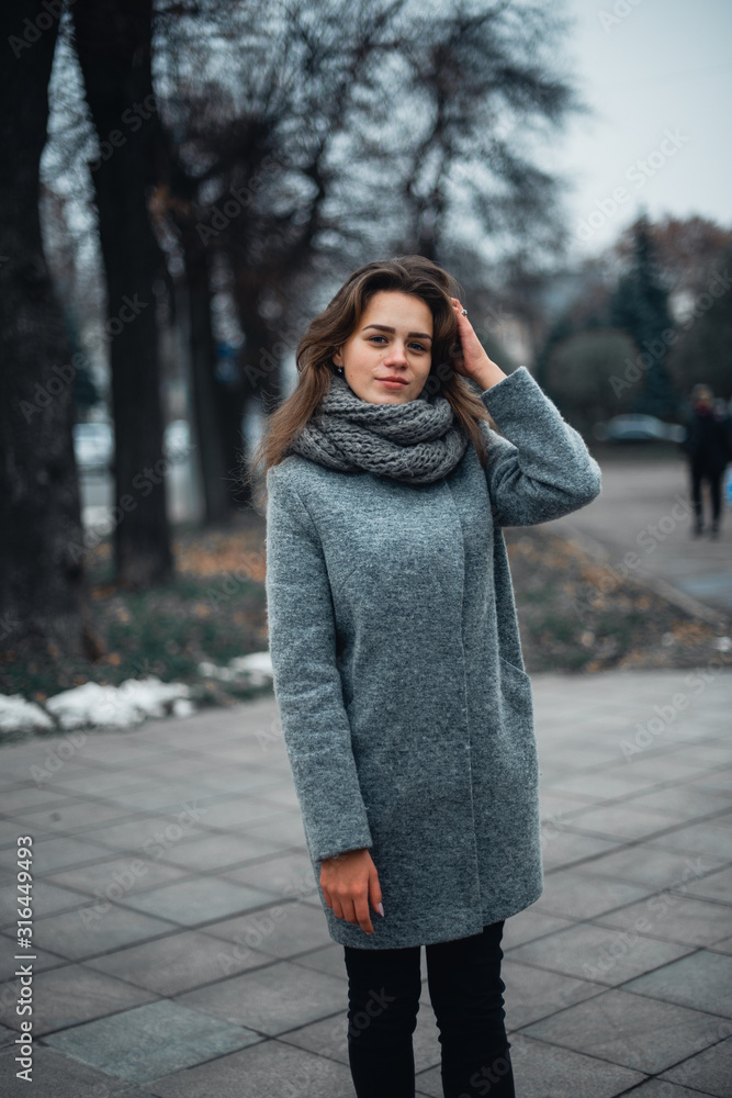 Girl in a gray coat in the winter in the city Girl in a gray coat in the winter in the city