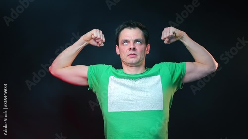 Portrait of a man with problematic self-esteem. Man showing biceps.