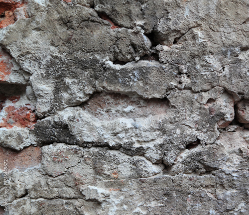 An old crumbling wall forms an irregular pattern that can be used for backgrounds.