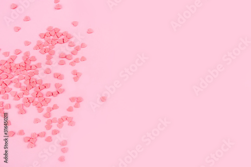 Pink background with tiny hearts. Valentine s day concept. Top view.