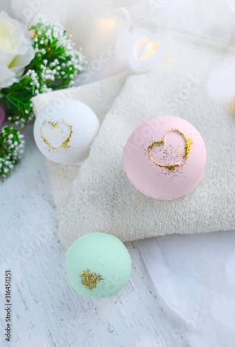 Romantic spa composition. Pastel bath bombs with flowers on towel. Valentines day, Mothers day, wedding lifestyle concept