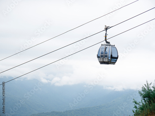 The cable car and grey sky on the background. Bottom view