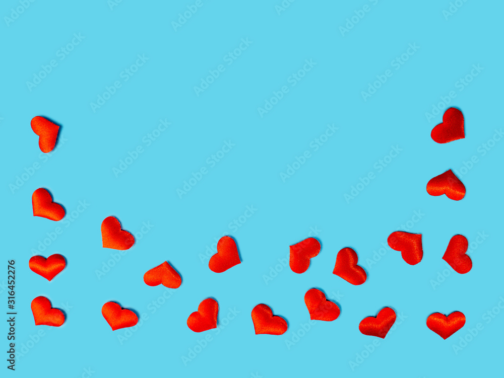 Lots of red hearts on a blue background. space for text for design