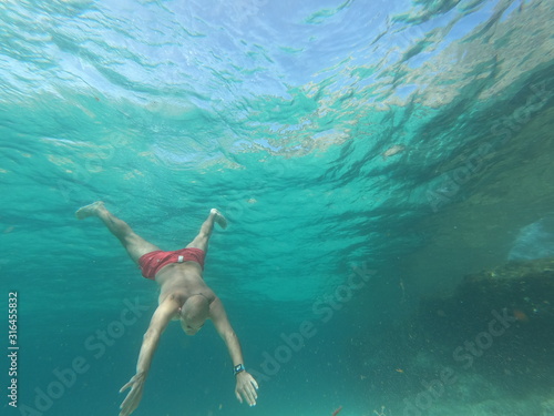   underwater man snorkeling in the sea with crystal-clear waters concept of holiday relax summer beach diver in the sea