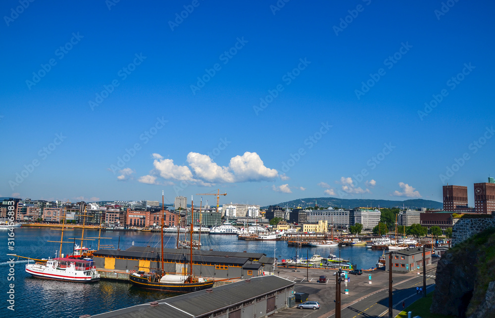 View on harbor at the Aker Brygge and  Radhuset (town hall), Oslo, Norway