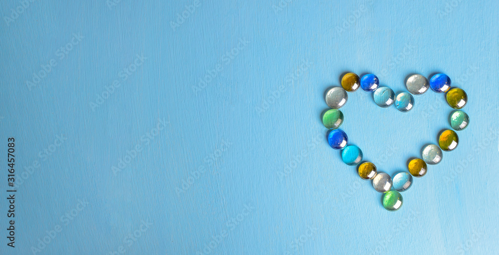 heart from glass stone on blue background heart from glass stone on blue background