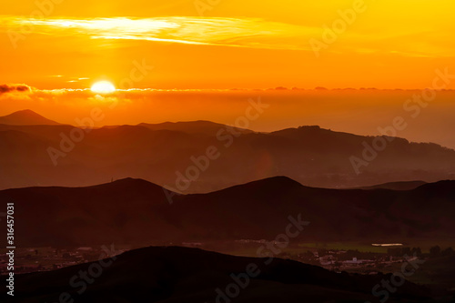 Orange Glow of Layered Silhouetted Mountains