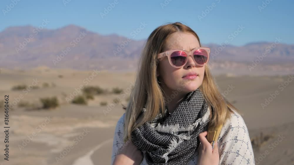 Travel and adventure portrait of an adventurous young woman traveler in desert Travel and adventure portrait of an adventurous young woman traveler in desert