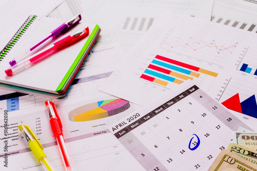 Tax day in america, background of documents preparing the payment with statistics and graphics. Tax day in america, background of documents preparing the payment with statistics and graphics.