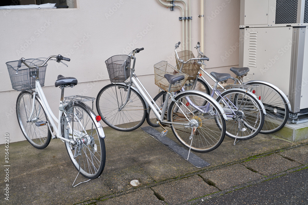 three bicycles parking at side walk
