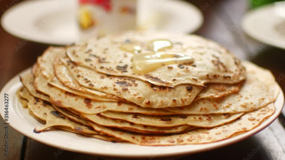 A stack of pancakes in a plate on the table. A stack of pancakes in a plate on the table.
