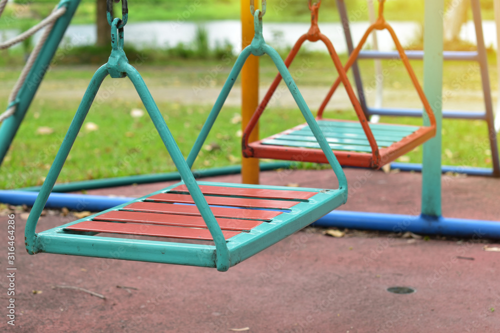 swing steel seat in playground for kid playing in outdoor park