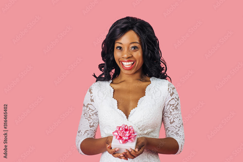 Portrait of young happy woman with big smile holding valentineÕs day romantic gift Portrait of young happy woman with big smile holding valentineÕs day romantic gift