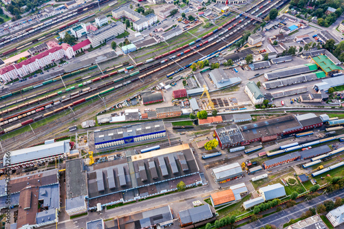 aerial top view on railway station in city. lots of freight wagons waiting for depot