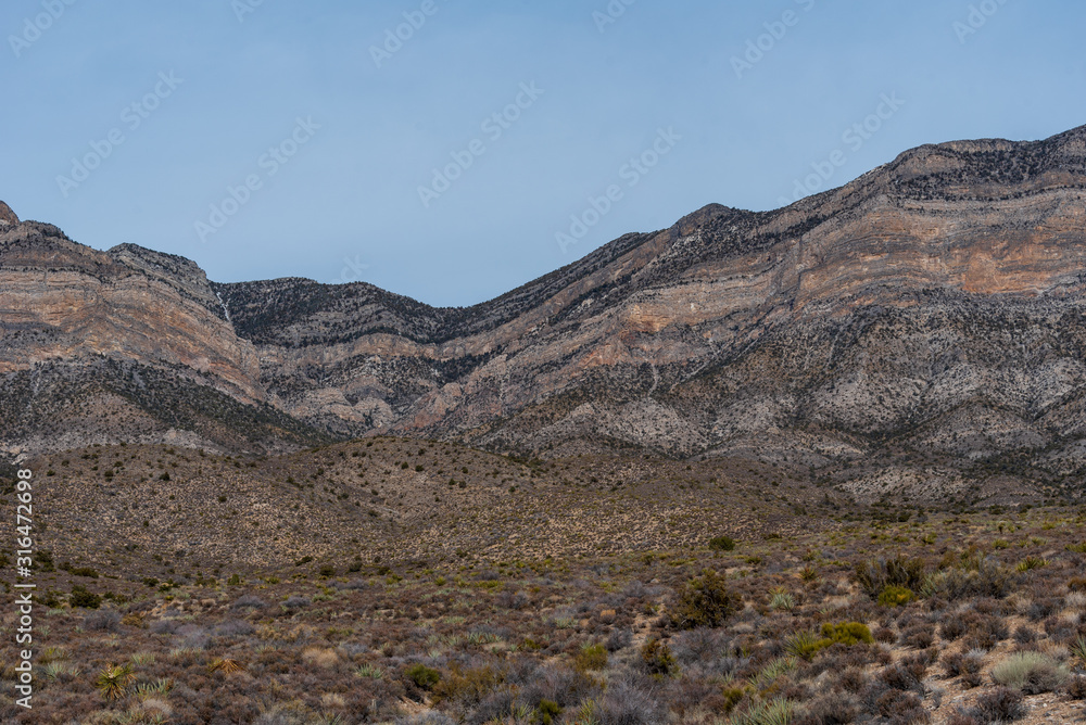 Low angle landscape of black and grey barren hillsides at Red Rock Canyon Conservation Area in Las Vegas, Nevada