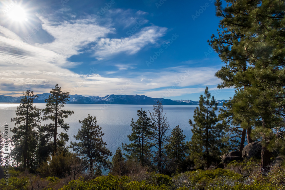 Landscape of trees overlooking Lake Tahoe and distant mountains in Nevada