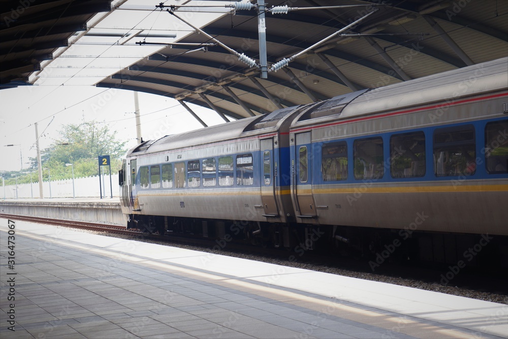 Train on the station with people commuting using mass transportation Train on the station with people commuting using mass transportation