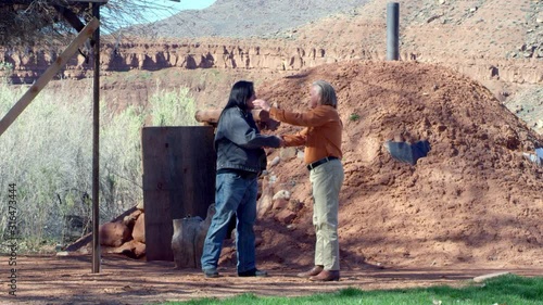 Native American Men Greet Each Other in Front of Hogan