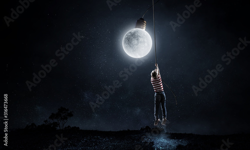 Foto Kid boy catching moon. Mixed media