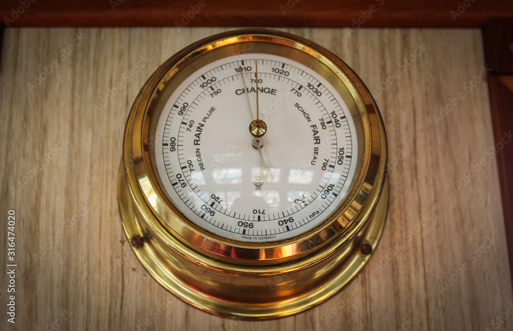 Analog barometer closeup on the navigating bridge of the ship Analog barometer closeup on the navigating bridge of the ship