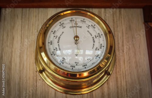 Analog barometer closeup on the navigating bridge of the ship