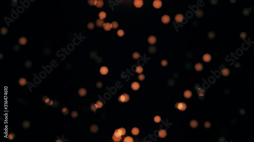 Dust particles bokeh gold lights on Black Background. 4k Footage