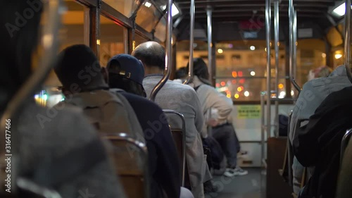 Backs of People commuting in a Tram at Nighttime 4k