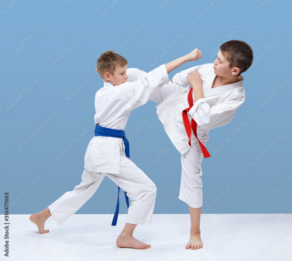 Two karate athletes are beating blows feet and punches Two karate athletes are beating blows feet and punches