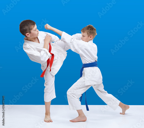 Sportsmen karate are beating kicks and punches