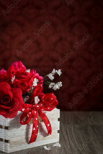 Red Rose Bouquet Gift with Red Heart Bow in a White Crate on a Table