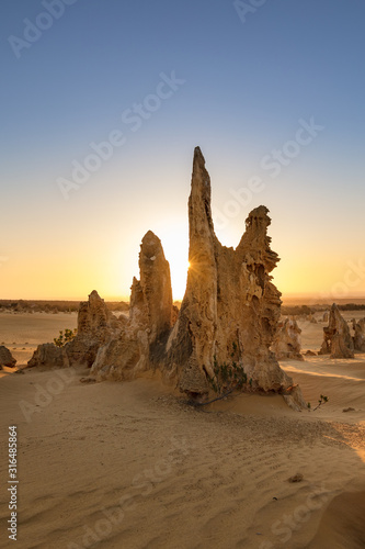 Sun setting behind the limestone stacks in the Pinnacles desert in the Nambung national park located north of Perth in Western Australia