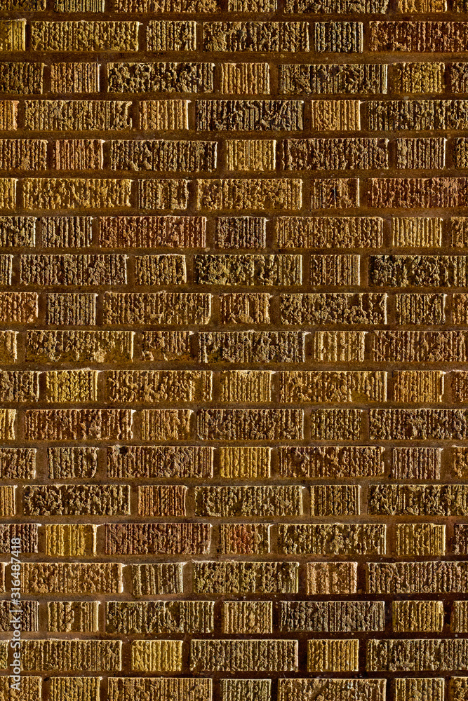 Greenish brown vintage brick wall texture background in Flemish bond brickwork pattern