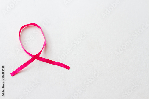 Pink ribbon breast cancer on white background. Symbol of breast cancer awareness.