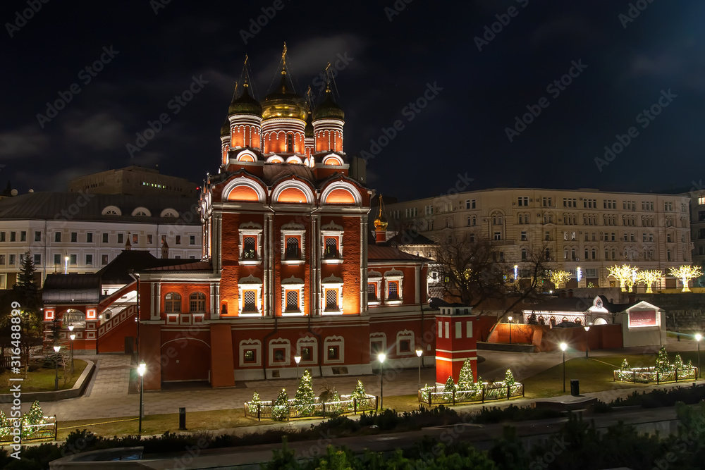beautiful red and white orthodox church at night
