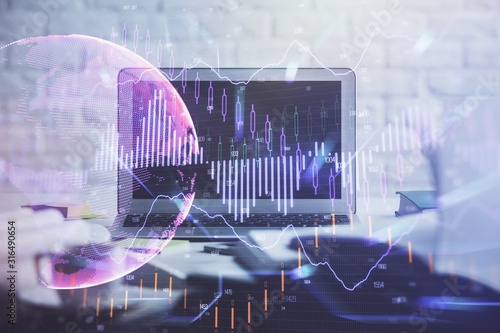 Financial chart drawing and table with computer on background. Double exposure. Concept of international markets.