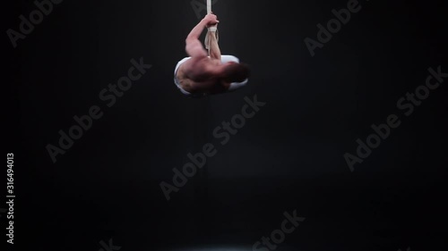 Muscular circus artist on the aerial straps. Concept of power, health and wellness  photo