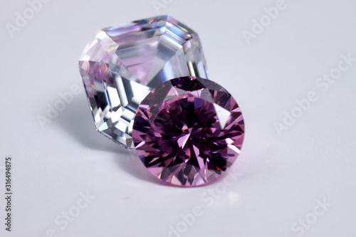 Macro shoots of pink color round shaped shiny diamond isolated