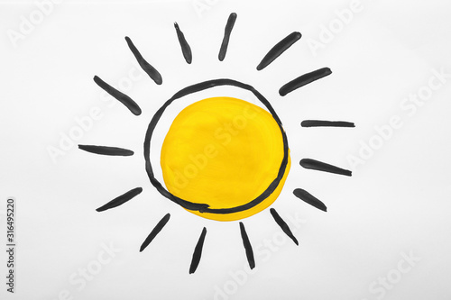 Child's painting of sun on white paper