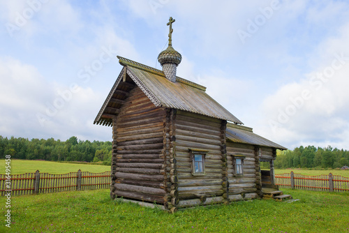 Ancient wooden chapel of St. Nicholas the Wonderworker close-up on an August cloudy day. Gomorovichi village, Leningrad region. Russia