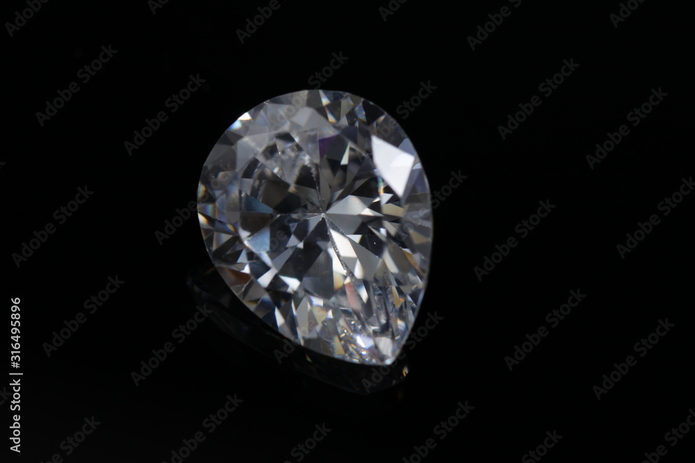 Close up shoot of shinny diamond that faceted to pear shapes isolated background Close up shoot of shinny diamond that faceted to pear shapes isolated background